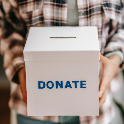 A person holding a donation box