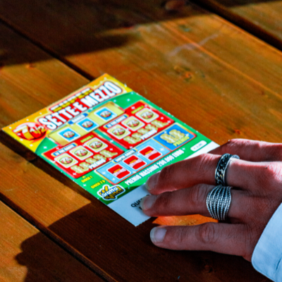 A person playing a scratchcard game